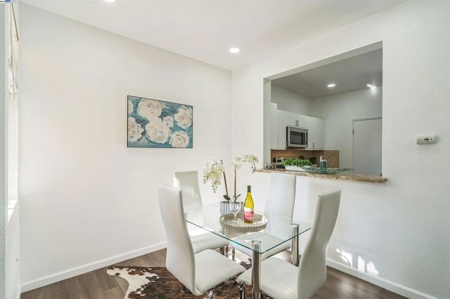 dining area with dark wood-type flooring