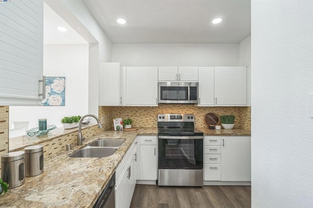 kitchen featuring backsplash, stainless steel appliances, white cabinets, and sink