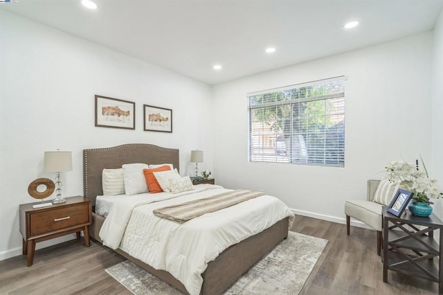 bedroom with dark hardwood / wood-style floors