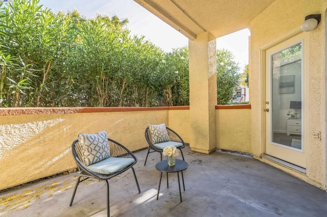 view of patio featuring a balcony