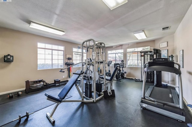 exercise room featuring a textured ceiling