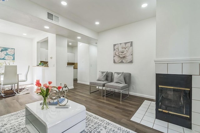 living room featuring a fireplace and dark hardwood / wood-style floors