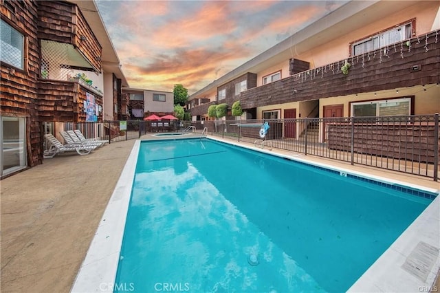 view of pool at dusk