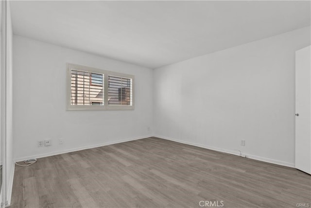 unfurnished room with hardwood / wood-style flooring