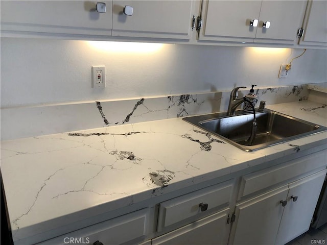 kitchen featuring sink and gray cabinetry