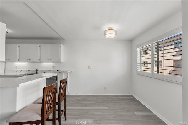 kitchen featuring white cabinets and light wood-type flooring