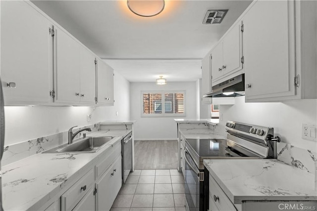 kitchen featuring stainless steel appliances, light tile patterned floors, light stone counters, sink, and white cabinetry