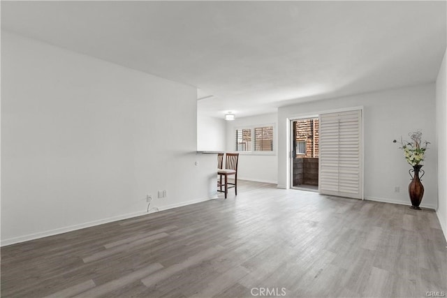 unfurnished living room with hardwood / wood-style flooring