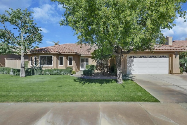 view of front of home featuring a garage and a front yard