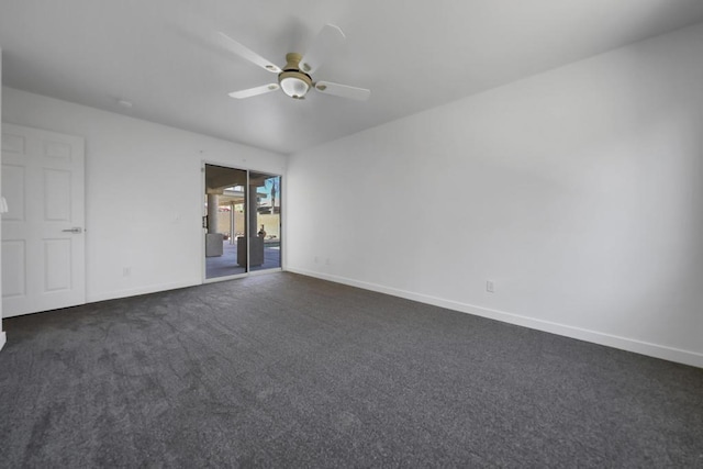 spare room featuring ceiling fan and dark colored carpet