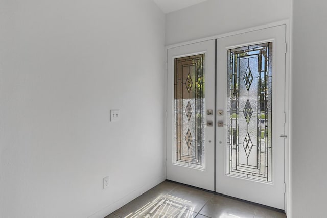 doorway with light tile patterned floors and french doors