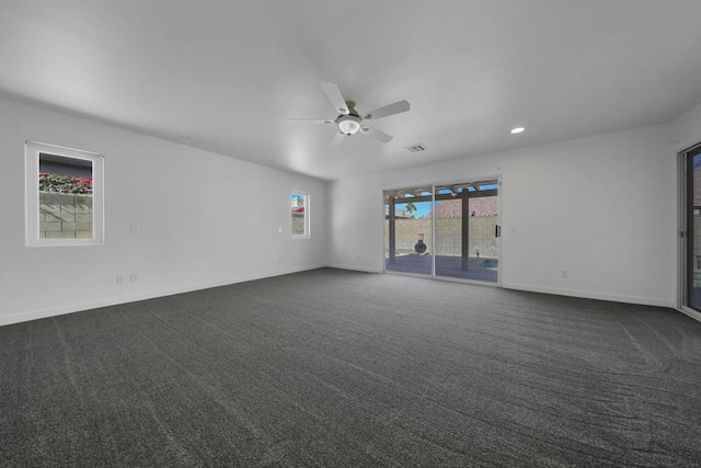 carpeted spare room with ceiling fan