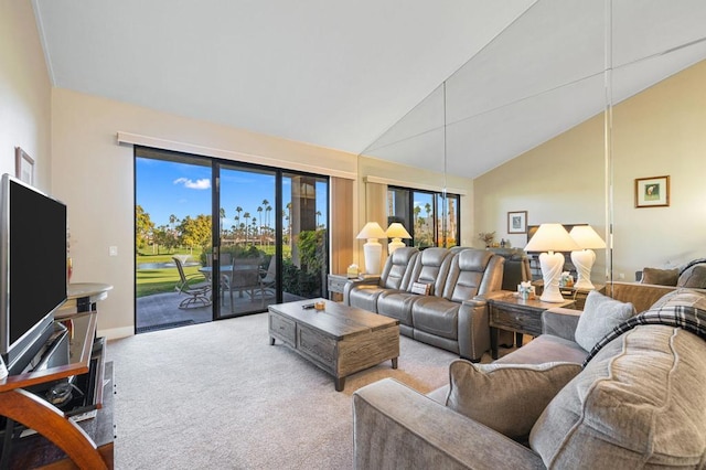 living room featuring light colored carpet and high vaulted ceiling