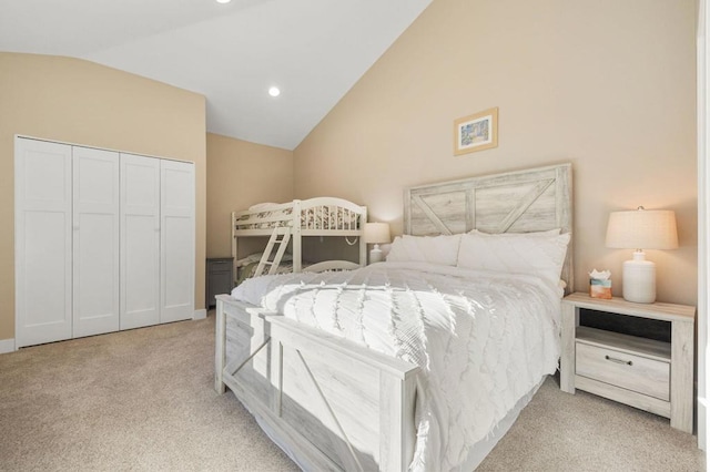 carpeted bedroom featuring a closet and vaulted ceiling