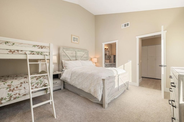 bedroom featuring high vaulted ceiling and light carpet