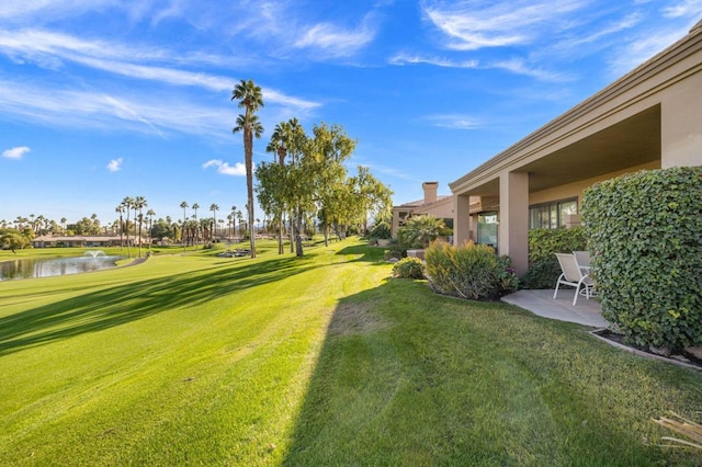 view of yard featuring a patio and a water view