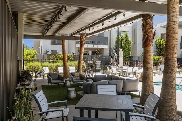 view of patio / terrace featuring a community pool and an outdoor hangout area