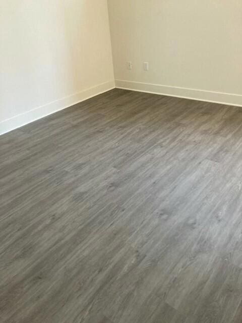 spare room featuring dark hardwood / wood-style flooring