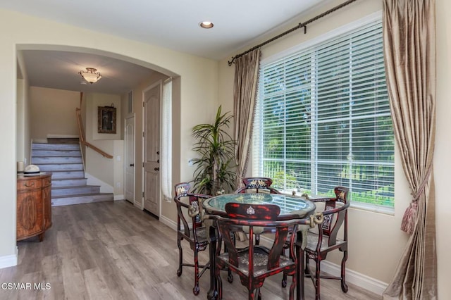 dining space with hardwood / wood-style flooring