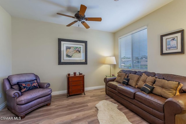 living room featuring ceiling fan and light wood-type flooring