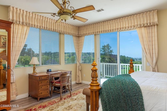 bedroom with ceiling fan, access to outside, and hardwood / wood-style floors