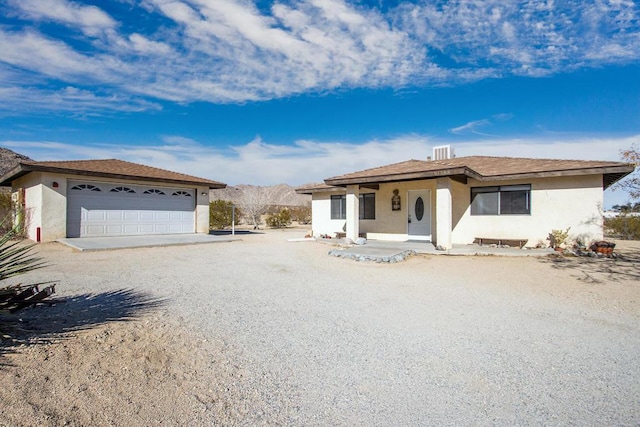 view of front facade featuring a garage and a mountain view