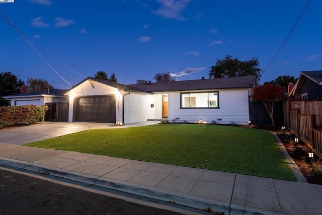 ranch-style house with a garage and a yard