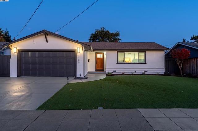 ranch-style house with a garage and a yard