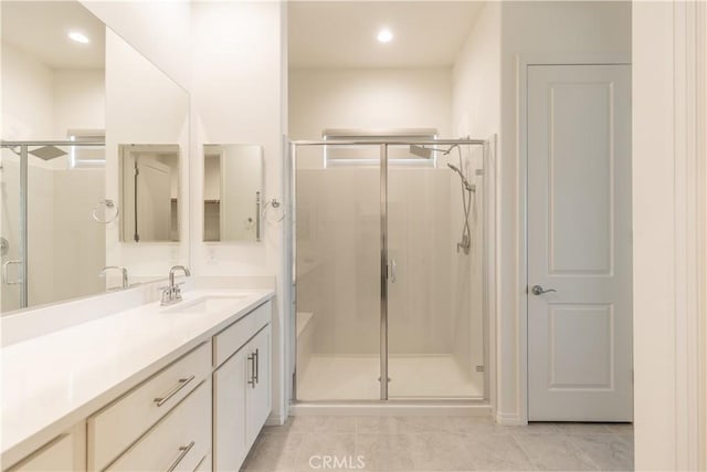 bathroom with vanity, a shower with shower door, and tile patterned flooring