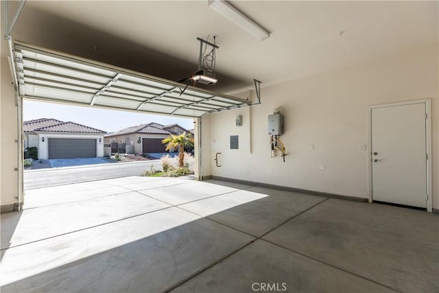 garage with a garage door opener and electric panel