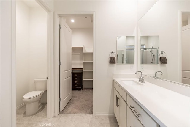 bathroom featuring vanity, tile patterned floors, and toilet