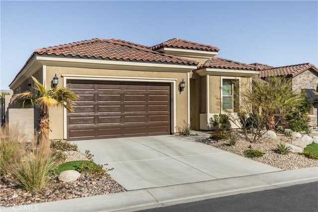 mediterranean / spanish house featuring a garage