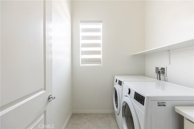 washroom with washing machine and clothes dryer