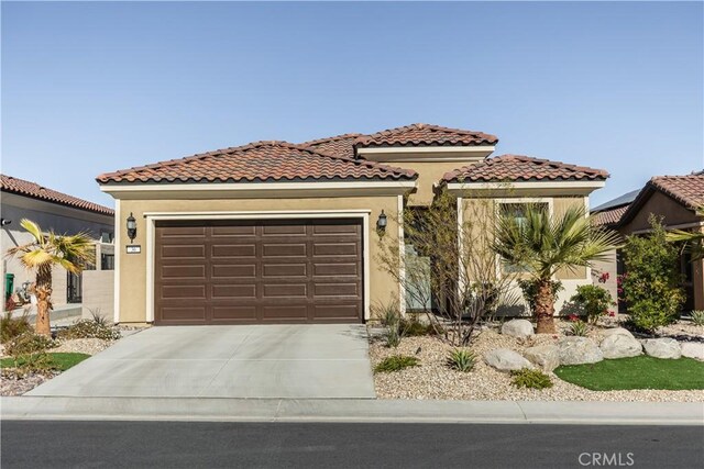 mediterranean / spanish house with a garage