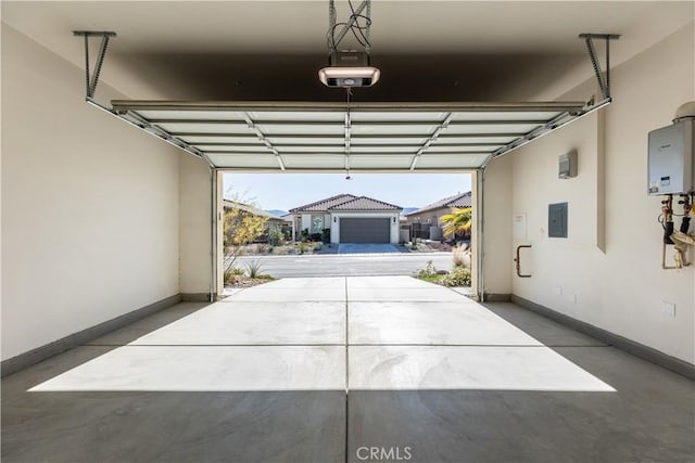 garage with a garage door opener, electric panel, and water heater