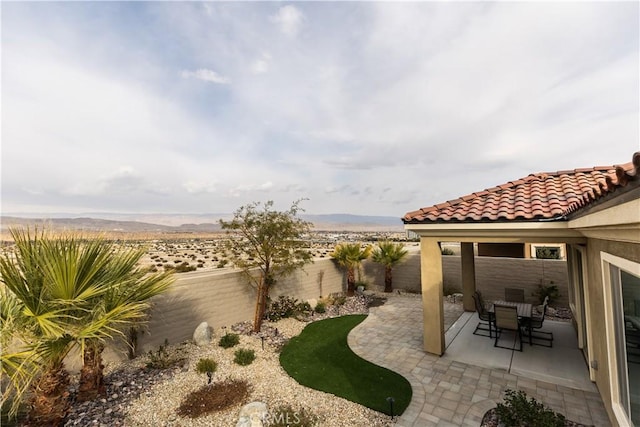 view of yard with a mountain view and a patio