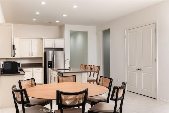 tiled dining area featuring sink