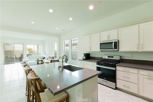 kitchen featuring stainless steel appliances, sink, and white cabinets