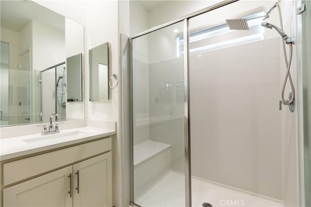 bathroom featuring vanity and an enclosed shower