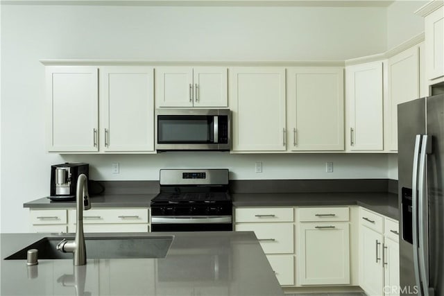 kitchen with sink, white cabinets, and appliances with stainless steel finishes