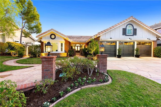 view of front of home with a garage and a front lawn