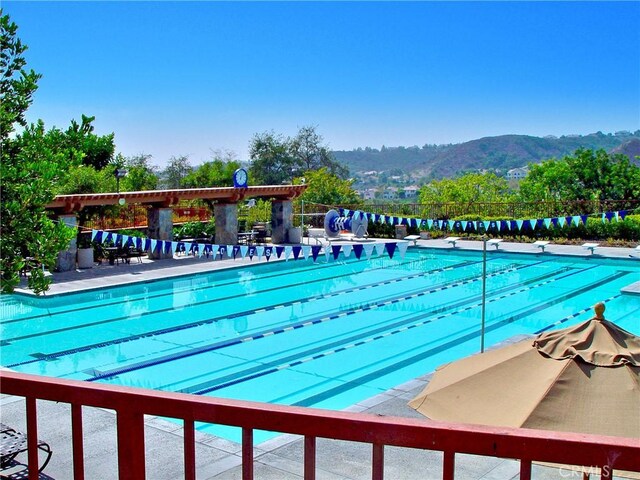 view of pool with a diving board and a mountain view