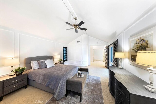 carpeted bedroom with ceiling fan and vaulted ceiling