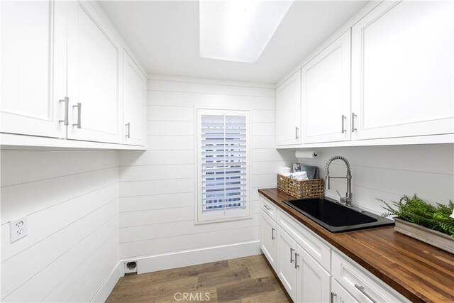 laundry area featuring light hardwood / wood-style floors and sink