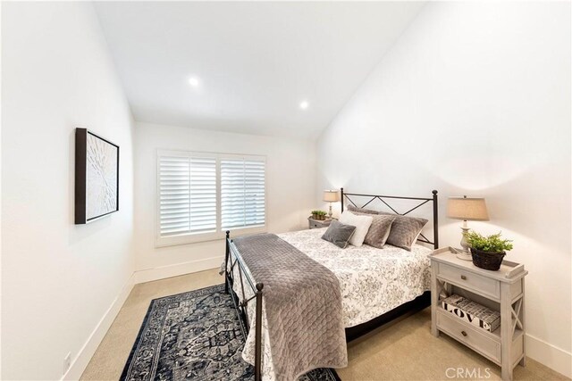 carpeted bedroom with vaulted ceiling