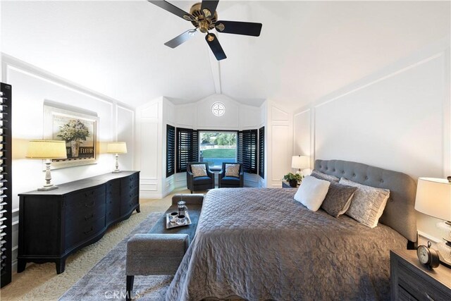 bedroom with ceiling fan, light colored carpet, and vaulted ceiling