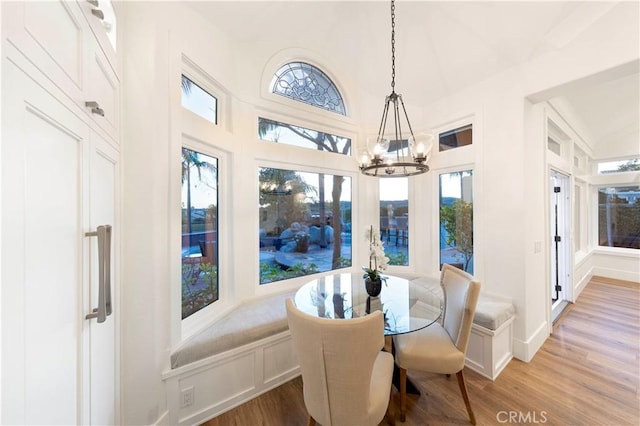 dining room with hardwood / wood-style flooring and a chandelier