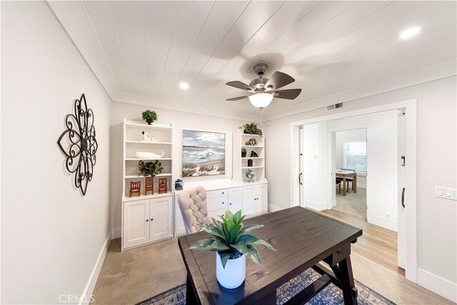 carpeted office with ceiling fan