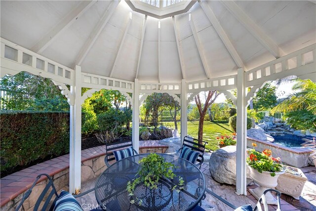 sunroom featuring vaulted ceiling with beams