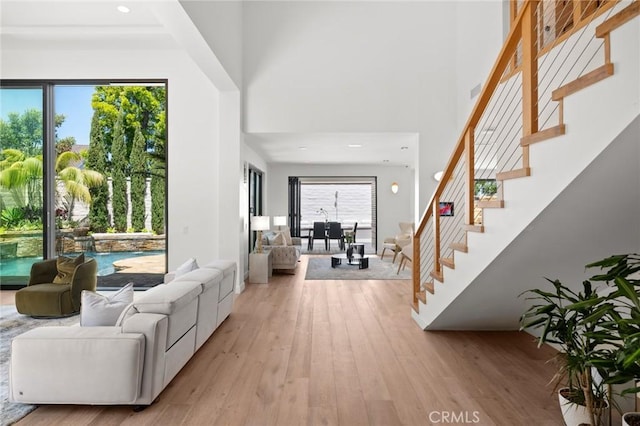 interior space with a high ceiling and light wood-type flooring